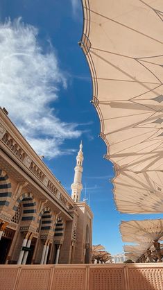 there are many large umbrellas that can be seen in the sky over some buildings