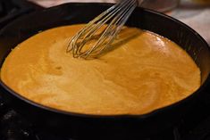 a whisk is being stirred in a skillet