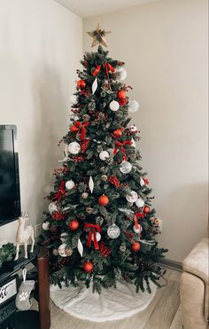 a decorated christmas tree with red and white ornaments