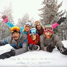 a group of people posing for a photo in the snow