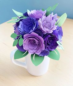 purple flowers in a white mug on a table