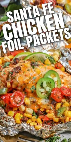 chicken foil packets with tomatoes, corn and peppers on them are ready to be eaten