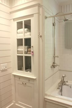 a bathroom with white walls and cabinets in it