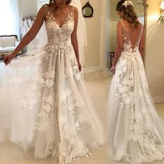 two women in wedding dresses looking at each other and one is wearing a dress with flowers on it