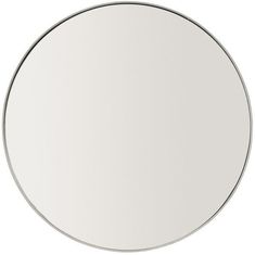 a white round mirror sitting on top of a table