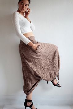 "Beautiful double layer fabric made of cotton/linen blend. High quality and stunning beauty. The fabric is unbleached and undyed, you can see the bark fibres in it! Subtle stripe pattern Drop-crotch style pants, baggy pants, tribal pants with a twist. 3 ways to wear. with drawstring on the hem. You can wear it with drawstring loose. Like a wide leg pants. Even look like A shape sweet skirt. You can also draw the string and get a balloon shape pants. Or...you can put the hem above your knee and g Beige Cotton Harem Pants For Fall, Fall Beige Cotton Harem Pants, Brown Cotton Harem Pants For Fall, Brown Relaxed Fit Harem Pants For Spring, Cotton Harem Pants For Fall, Spring Harem Parachute Pants With Pockets, Fall Cotton Harem Pants, Spring Baggy Drop Crotch Harem Pants, Hippie Harem Pants For Spring Loungewear