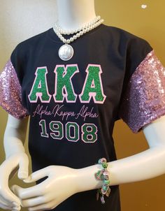 **This Item is in high demand, due to the hand sewing that is required to complete this order it will take between 2-3 weeks to ship. Thanks! This re-designed Sequin Sleeve Tee has Glitter Bling Double Applique Greek Letters and Year. This tee will have you Sparkling all over the place. This tee will be also be available for Zetas, Deltas and SGRho members. This tee will not disappoint, you will love the shine from the front of the sleeves. Please allow 5 to 10 business days to ship due to tees Aka Aesthetic, Aka Attire, Aka Apparel, Sorority Paraphernalia, Black Sequin Jacket, Sorority Tees, Rhinestone Tees, Star Tshirt, Aka Sorority