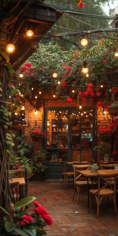 an outdoor dining area with tables, chairs and hanging flowers on the roof overhangs