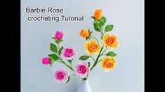 crocheted flowers in a white vase with the words barbie rose crocheting tutor