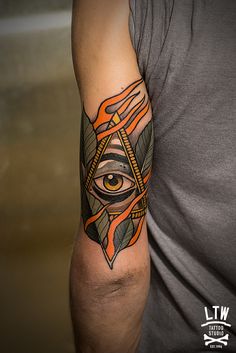 a man with an all seeing tattoo on his arm