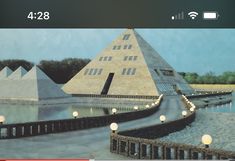 an image of a large building with lights on it's sides and in front of the pyramid