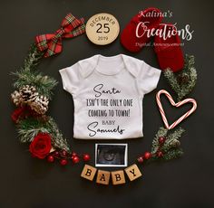 a baby's first christmas outfit and shoes are laid out on top of a wreath