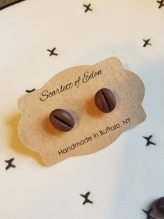 two chocolate earrings sitting on top of a white plate