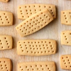 several crackers are arranged on a wooden surface with holes in the middle to make them look like they were made out of cheese