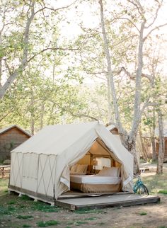 a tent is set up in the woods