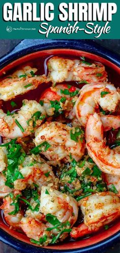 garlic shrimp with spinach and parsley in a red bowl