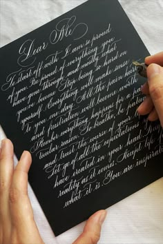 a person writing on a piece of paper with a fountain pen and nib in it