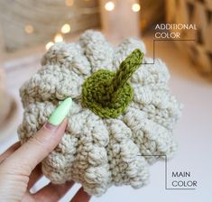 a crocheted flower is being held by a woman's hand and labeled with instructions