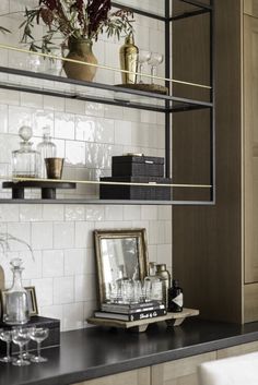 the shelves in this kitchen are filled with glassware