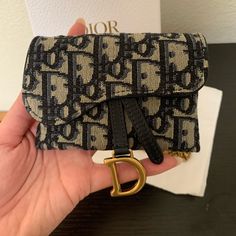 100% Authentic. Blue Dior Oblique Jacquard. Has Antique Gold-Finish Metal 'D' Stirrup. Removable Vintage Gold Chain And Belt Loops On The Back. Dimensions: 12.5 X 8 X 3.5 Cm / 5 X 3 X 1.5 Inches Ideal For Credit Cards And Id, But Can Also Be Used As Crossbody Wallet On Chain. Made In Italy. Comes With Dust Bag And Box. No Trades. Brand New, Unused. Dior Saddle Card Holder, Dior Wallet Aesthetic, Designer Wallet Aesthetic, Dior Saddle Wallet On Chain, Expensive Wallet, Dior Saddle Wallet, Expensive Wishlist, Dior Wallet On Chain, Designer Wallets For Women