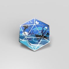 a blue and white origami dice with dolphins in the ocean on it's sides