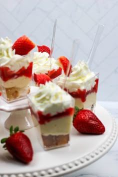 strawberry shortcakes with whipped cream and strawberries on a white plate, ready to be eaten