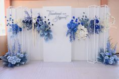 an arrangement of blue and white flowers on display