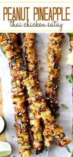 grilled pineapple chicken skewers on a cutting board with lime wedges