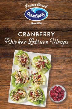 cranberry chicken lettuce wraps on a white plate next to a bowl of cranberries