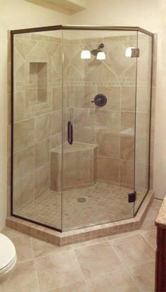 a walk in shower sitting inside of a bathroom