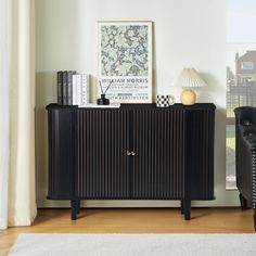 a living room with a black and white striped cabinet