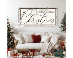 a living room decorated for christmas with presents on the floor and a sign above it that says have yourself a merry little christmas