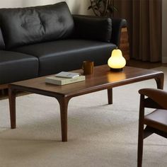 a living room with a black leather couch and coffee table