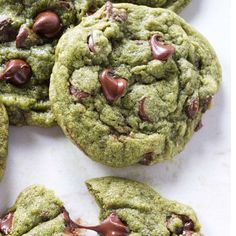 green chocolate chip cookies on a white surface