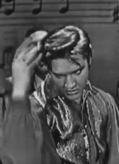 elvis presley singing in the 1950's with musical notes behind him and his hands on his head