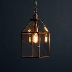 a light hanging from a chain on a dark wall with no one in it or someone out there