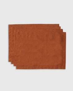 three orange napkins sitting on top of each other