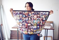 a woman holding up a large photo collage with pictures on it's back