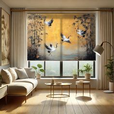 a living room filled with furniture and a painting on the window sill above it