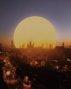 the sun is setting over a city with tall buildings