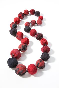 Vermillion & Black Kantha Necklace by Mieko Mintz . Soft beads are filled with lightweight cotton batting in this playful necklace brimming with the ebullient colors of silk and cotton fabrics and traditional kantha stitching. Limited quantities available. Satin Flowers Diy, Knots Jewelry, Diy Fabric Jewellery, Textile Necklace, Cotton Necklace, Polymer Clay Bracelet, Silk Necklace, Gray Jewelry, Fiber Jewelry