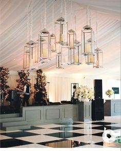 an elegant wedding reception with chandeliers and flowers on the dancefloored floor