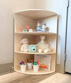 a corner shelf with toys and books on it in a child's playroom