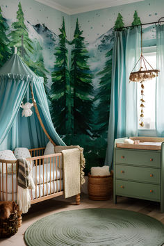 a baby's room decorated in blue and green with trees painted on the wall