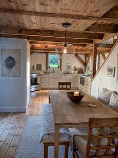 a wooden table sitting in the middle of a kitchen