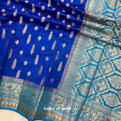 Blue saree blouse  , Georgette saree with zari borders , Semi georgette sarees for women , FREE SHIPPING This is a handwoven semi  georgette saree in  beautiful eye catching  colors . Each saree  comes with zari butis all over the body ,  floral zari borders on both the sides  and a very heavily embroidered  pallu . All the sarees come with  an unstitched blouse piece .  MATERIAL : Semi  Georgette  MEASUREMENTS : Width of the Saree :  44  Inches  Length of the Saree :  5.50 meters  Matching  Blo Blue Dola Silk Pre-draped Saree With Zari Weaving, Blue Bollywood Banarasi Silk Pre-draped Saree, Blue Pre-draped Saree With Zari Weaving, Blue Katan Silk Pre-draped Saree With Zari Work, Blue Pre-draped Saree With Motifs For Festivals, Semi-stitched Blue Saree With Dupatta, Blue Katan Silk Dupatta With Motifs, Blue Semi-stitched Designer Saree, Unstitched Blue Saree