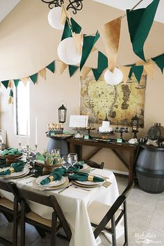 a dining room table is set with green and white place settings for an elegant celebration