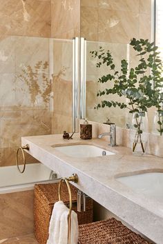 a bathroom with two sinks and a large mirror in it's corner, next to a bathtub