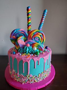 there is a cake decorated with candy and lollipops