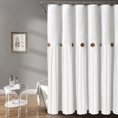 a white shower curtain with gold circles on it